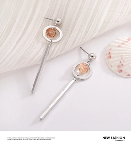 Detail of silver drop earrings with champagne gemstone inlay against elegant background