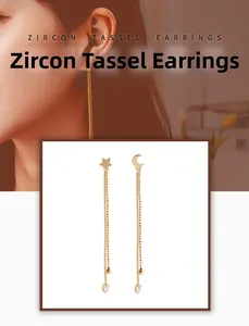 Close-up of asymmetrical star and moon tassel earrings with zircon stones on a model