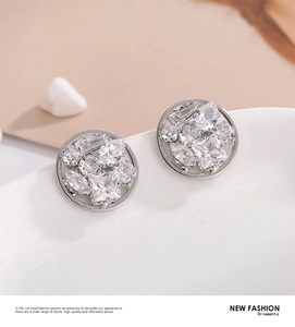 Detailed view of cluster stud earrings with multi-cut sparkling zircon crystals in silver