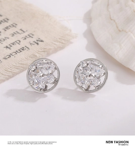 Detail of sparkling starburst stud earring with zircon inlay on natural linen texture