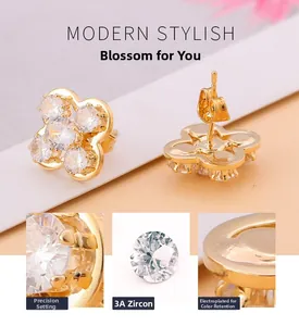 Détails macro de boucles d'oreilles trèfle doré avec zircon 3A et incrustation soignée