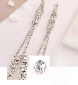 Detail view of snowflake tassel earrings featuring 3A grade zircon stones and silver plating