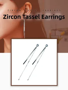 Detail of silver long tassel earrings with sparkling zircon studs on a female model