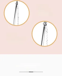 Detail of silver plated tassel earrings with snake chain structure and polished finish