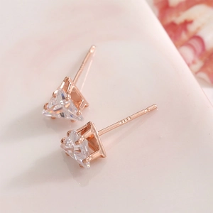 Close-up of rose gold triangle zircon earrings with S925 sterling silver marks