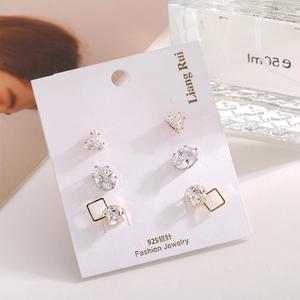 Detailed view of three pairs of sparkling zircon stud earrings on a card with 925 silver needles