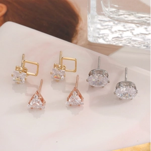 Macro shot of geometric zircon earrings set with S925 silver needles on marble tray