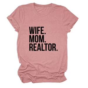 Close-up of WIFE MOM REALTOR slogan printed on pink soft cotton short sleeve T-shirt