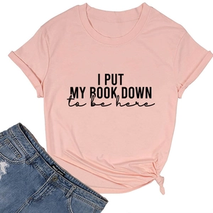 Detail of pink cotton t-shirt featuring 'I PUT MY BOOK DOWN' slogan and bottom knot style