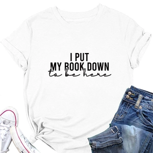 Flat lay of a white cotton T-shirt with 'I PUT MY BOOK DOWN' print and denim jeans