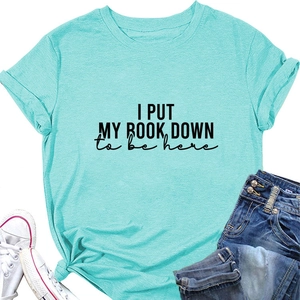 Close-up of light blue T-shirt featuring I PUT MY BOOK DOWN print and cotton texture