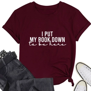 Detail of burgundy T-shirt with I PUT MY BOOK DOWN print and tie-knot hem detail