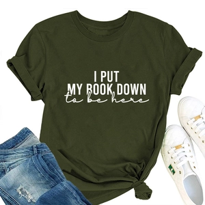 Detail of olive green t-shirt with I Put My Book Down print and knotted hem design