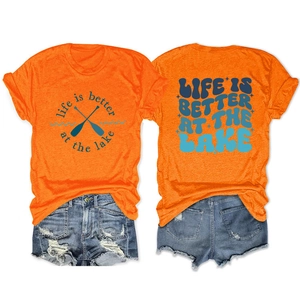 Detail of orange t-shirt with Life is Better at the Lake print and denim shorts