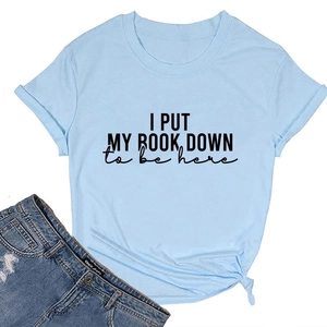 Detail of light blue T-shirt with I PUT MY BOOK DOWN slogan and side knot design
