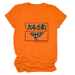 Detailed view of the leopard heart print on a bright orange short-sleeve women's T-shirt
