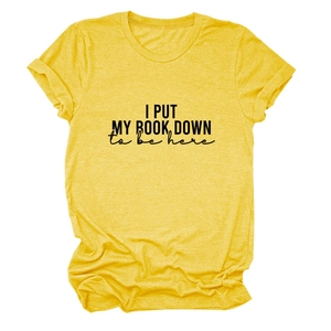 Detail of the 'I PUT MY BOOK DOWN' print on a soft yellow cotton short sleeve T-shirt