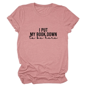 Detail of rose pink crewneck T-shirt featuring 'I PUT MY BOOK DOWN' black text print