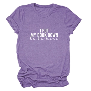 Detail of purple cotton T-shirt featuring I Put My Book Down slogan and rolled sleeves