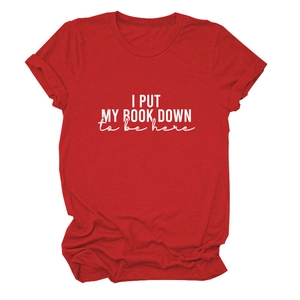 Detail of red cotton T-shirt featuring I Put My Book Down white graphic print