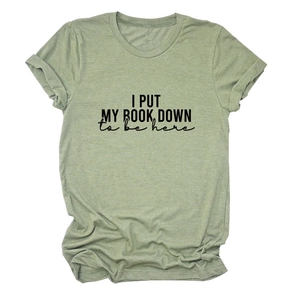 Detail of rolled sleeves and printed text on a light green cotton casual t-shirt