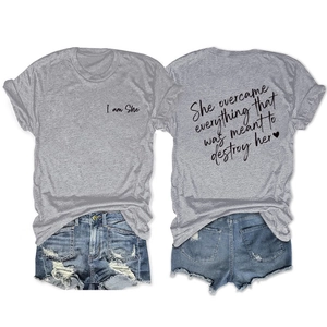 Flat lay view of a grey t-shirt featuring inspirational text on the back and front