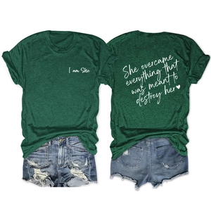 Front and back detail of dark green cotton T-shirt with 'I am She' inspirational text