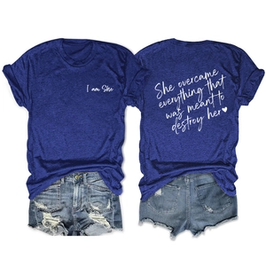 Detail of navy T-shirt with 'I am She' print and distressed denim shorts outfit set