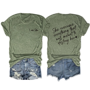 Detail of green motivational t-shirt and distressed denim shorts in a flat lay view