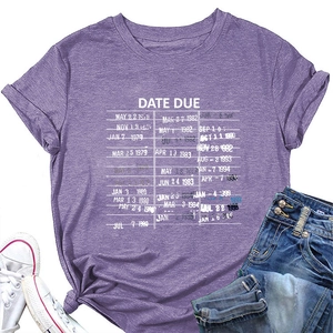 Flat lay of purple cotton T-shirt with vintage date due print, sneakers and denim shorts