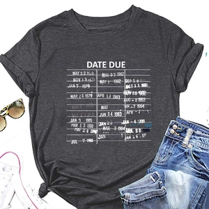 Flat lay of a grey T-shirt with a vintage library card print and casual accessories