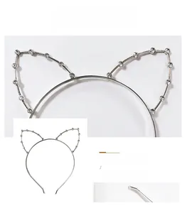 Macro detail of silver cat ear headband with sparkling rhinestones and smooth metal ends