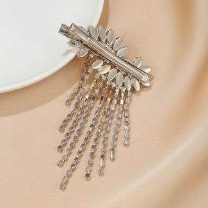 Sparkling silver floral rhinestone hair clip with long tassel fringe on silk background