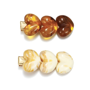 Retro acrylic heart hair clips in amber and cream marble resin on gold duckbill clip