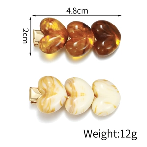 Retro acrylic heart hair clip with amber and marble textures in a 4.8cm compact design