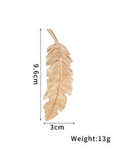 Detail view of gold feather hair clip with dimensions of 9.6cm length and 3cm width