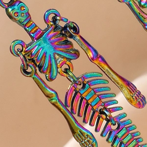 Rainbow plated skeleton drop earrings featuring a detailed gothic skull design