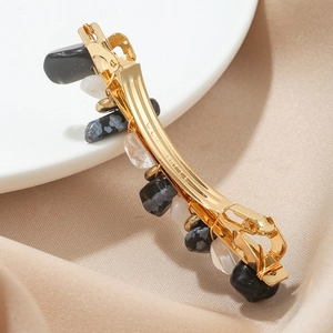 Elegant gold hair clip with natural polished stones and secure spring closure