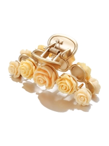 Detail of champagne resin roses on a large golden metal hair claw clip with mirror reflection