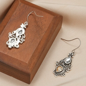 Vintage gunmetal drop earrings with hollow patterns and teardrop crystals set on wood