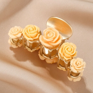 Elegant champagne rose hair claw clip for women on a luxurious satin background