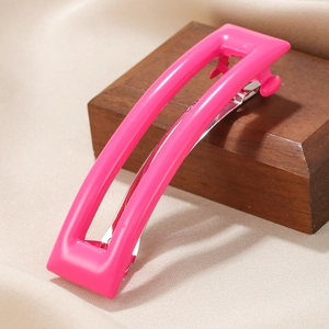 Rectangle hollow acetate hair clip in vibrant rose pink with metal spring mechanism