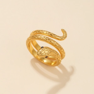 Macro shot of gold-plated stainless steel snake ring with engraved scales and black stone eyes