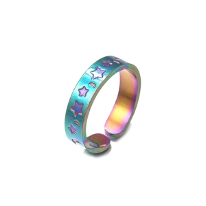 Macro shot of iridescent rainbow snake ring with etched stars and moon patterns