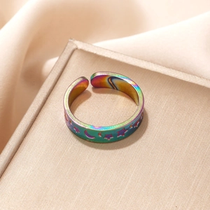 Detailed close-up of rainbow-plated stainless steel ring with star and moon cut-outs