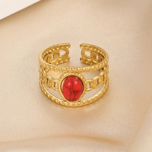 Detail of red oval gemstone on gold-plated stainless steel open ring with hollow chain