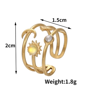 Detail of gold celestial ring featuring moon, star motifs and inlaid yellow bead