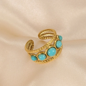 Detail of bohemian gold stainless steel open ring with five vibrant turquoise stones