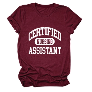 Detailed flat lay of burgundy nursing assistant t-shirt with bold white printed lettering