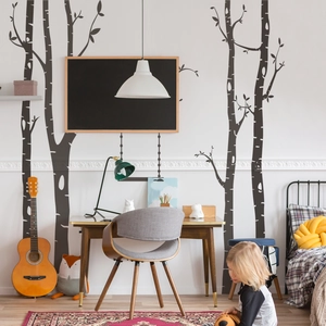 Modern Nordic style birch tree wall decals shown in a cozy study room with furniture